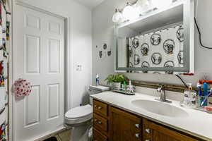 Full bath with vanity, light tile patterned floors, and a shower with shower curtain
