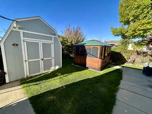 View of shed and gazebo and flower garden
