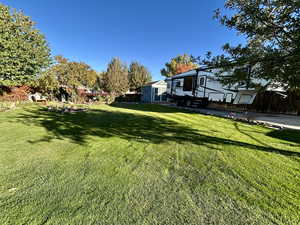 View of the garden, RV pad and featuring an outbuilding