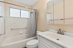 Bathroom with vanity and shower / bath combo with shower curtain
