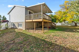 View of side of home featuring a fenced backyard, a deck, and stairway