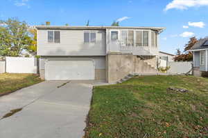 View of front of property featuring driveway and an attached garage