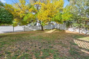 Fenced backyard with an outbuilding