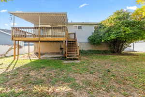 Rear view of property featuring a deck and stairway