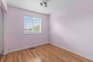 Unfurnished room featuring baseboards and light wood-type flooring