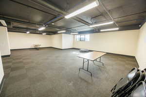 Below grade area featuring baseboards and carpet flooring