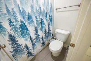 Full bath featuring tile patterned flooring and shower / tub combo