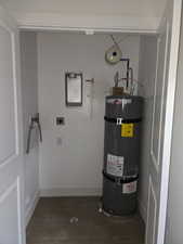 Utility room featuring secured water heater