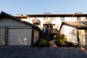 View of front of property featuring stairway and a wooden deck