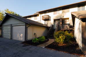 View of front of house featuring stairs and a garage
