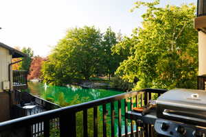 Balcony with area for grilling and a water view