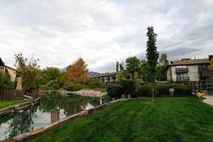 View of community with a water view and a yard