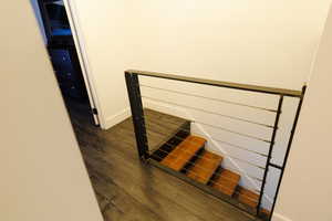 Stairs featuring wood finished floors and baseboards