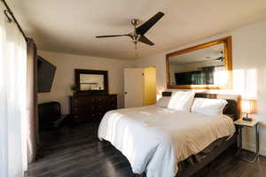 Bedroom featuring dark wood-type flooring and a ceiling fan