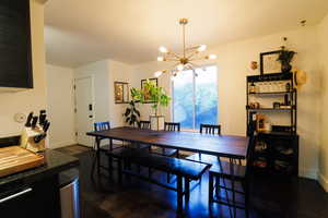 Dining room with a chandelier and baseboards