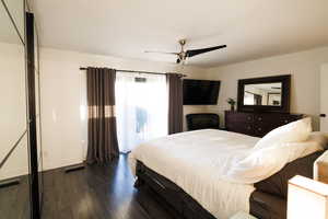 Bedroom with dark wood-style floors and a ceiling fan