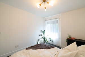 Bedroom with baseboards and wood finished floors