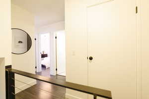 Hallway with wood finished floors and baseboards