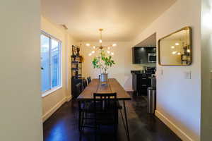 Dining room with a chandelier and baseboards