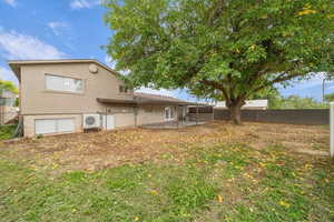 Back of house with a patio, brick siding, a fenced backyard, and stucco siding