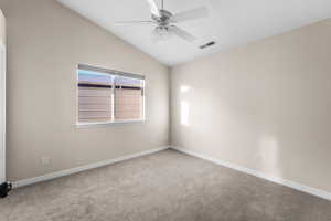 Carpeted spare room with lofted ceiling and ceiling fan