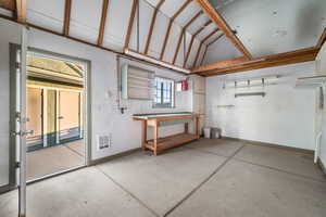 Garage featuring a workshop area and baseboards