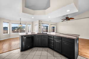 Kitchen with dark cabinetry, a kitchen island with sink, recessed lighting, ceiling fan, and dishwasher