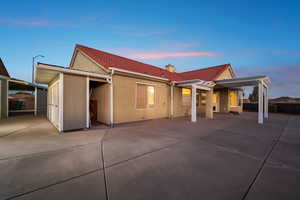 View of front of home with a tile roof, a chimney, and stucco siding