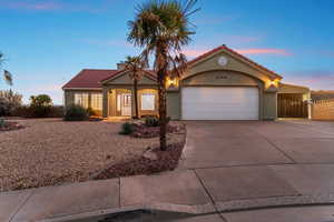 Mediterranean / spanish home featuring concrete driveway, a tiled roof, stucco siding, an attached garage, and covered porch