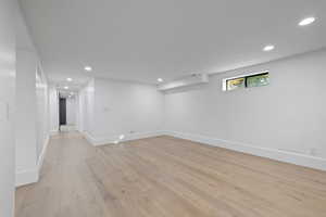 Basement with recessed lighting and light wood-type flooring