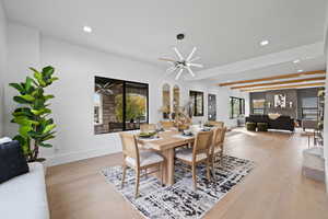 Dining space with light wood-style flooring, recessed lighting, plenty of natural light, and beam ceiling