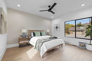 Bedroom featuring light wood finished floors, ceiling fan, and recessed lighting