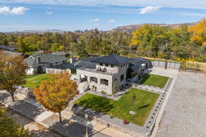 Aerial view of property and surrounding area featuring a mountain backdrop