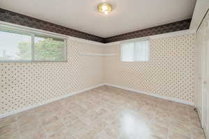 Unfurnished room featuring light tile patterned flooring