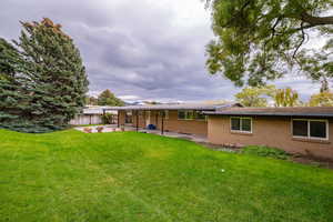 Back of property featuring brick siding and a patio area