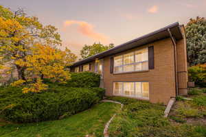 Front view of house with brick siding and a yard