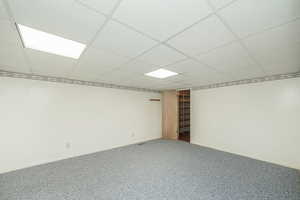 Unfurnished room with carpet and a paneled ceiling