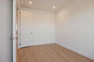 Unfurnished room with light wood finished floors and recessed lighting