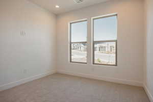 Spare room featuring light carpet and recessed lighting