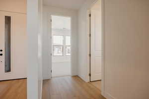 Corridor featuring light wood-style floors and baseboards