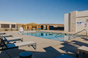 Community pool with a patio