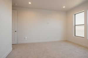 Unfurnished room featuring light colored carpet and recessed lighting