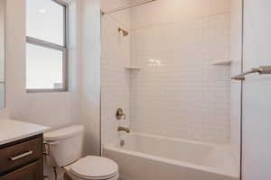 Bathroom featuring vanity and  shower combination