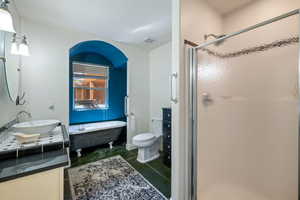 Full bath with vanity, a garden tub, and a stall shower