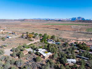 View of rural area with a desert landscape and a mountainous background