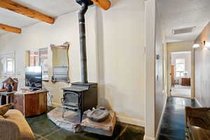 Detailed view of a wood stove and beam ceiling