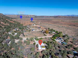 Aerial view of property's location with a mountain backdrop and rural landscape