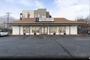 View of property featuring uncovered parking