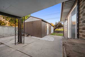 View of patio / terrace with a shed