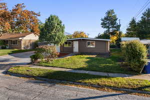 Single story home with a front lawn and a garage